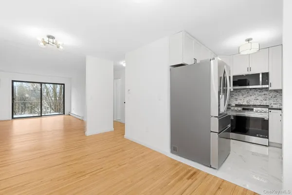 a kitchen with stainless steel appliances a refrigerator and a stove top oven