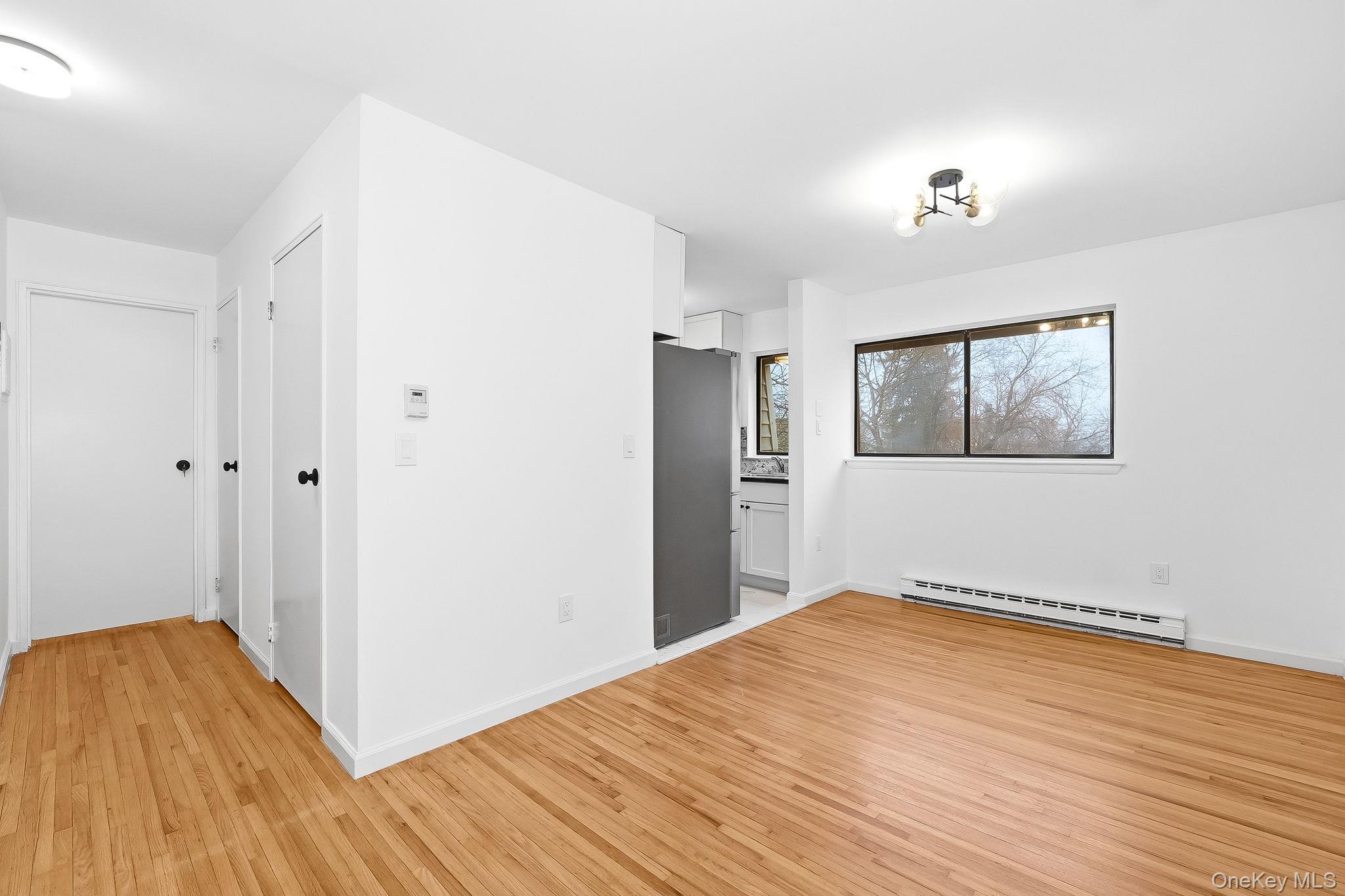 20 Pierces Road, Unit 36 Newburgh, NY 12550 - Photo 14 of 36 a view of empty room with wooden floor and window