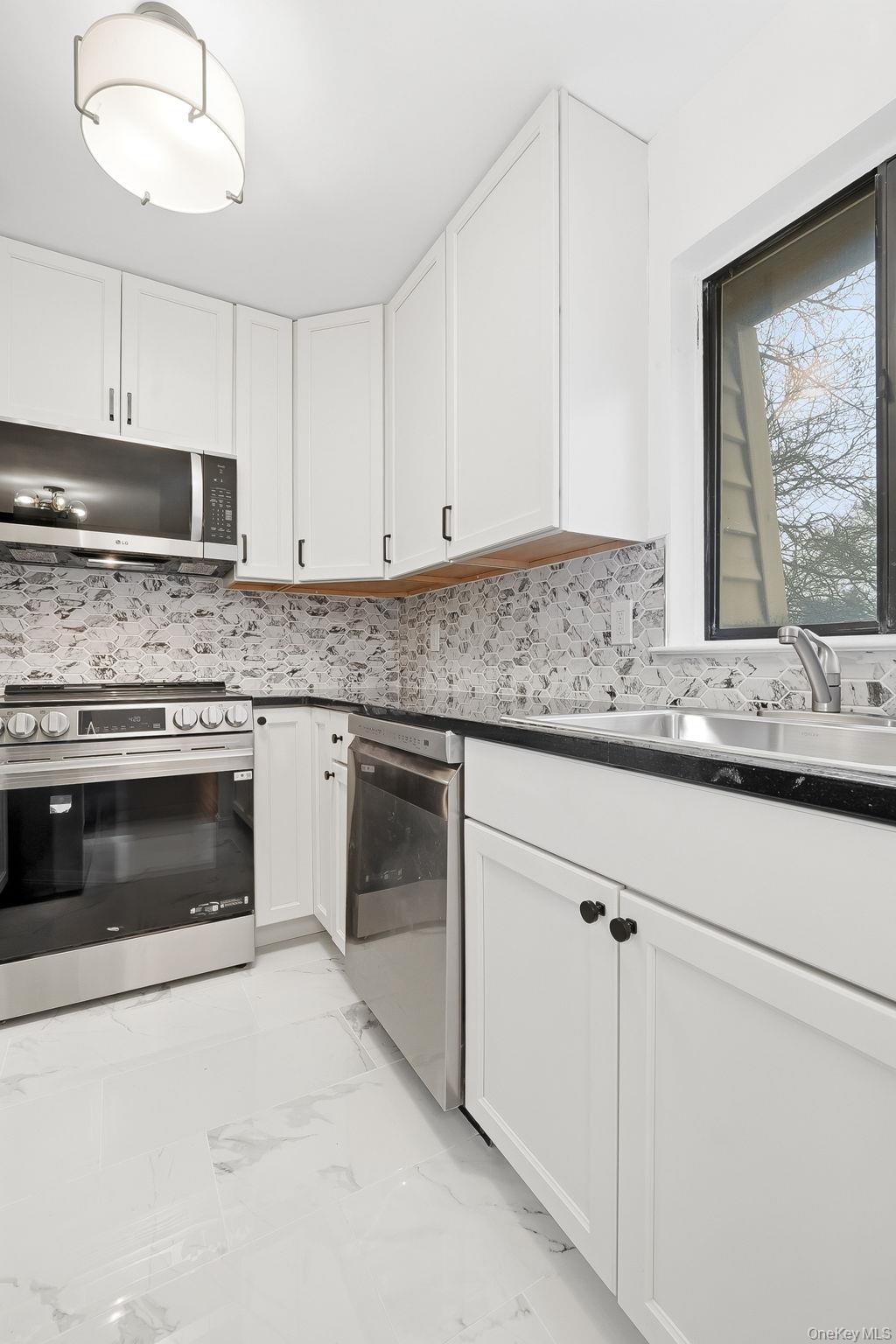 20 Pierces Road, Unit 36 Newburgh, NY 12550 - Photo 15 of 36 a kitchen with granite countertop white cabinets and white stainless steel appliances
