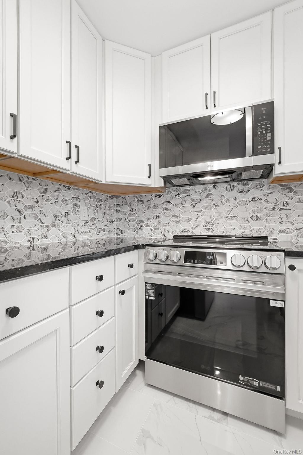 20 Pierces Road, Unit 36 Newburgh, NY 12550 - Photo 20 of 36 a stove top oven sitting inside of a kitchen