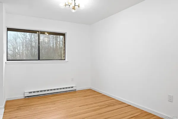 a view of a room with wooden floor and pool table