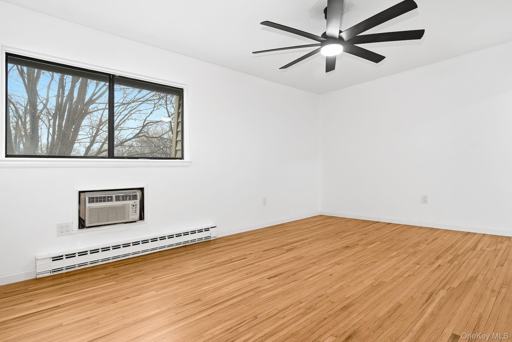 20 Pierces Road, Unit 36 Newburgh, NY 12550 - Photo 24 of 36 a view of an empty room with a window and wooden floor