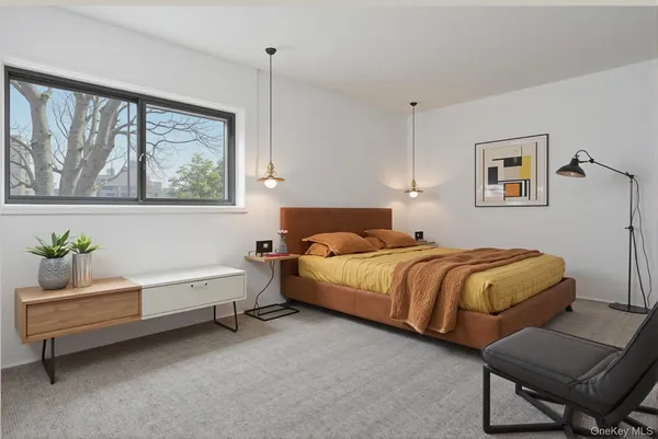 a spacious bedroom with a bed and a window