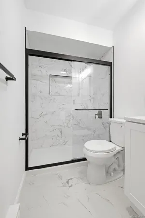 a bathroom with a toilet and a shower