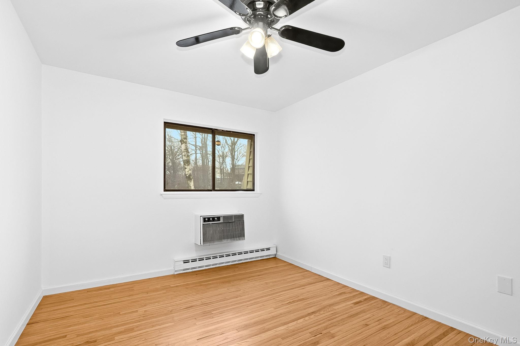 20 Pierces Road, Unit 36 Newburgh, NY 12550 - Photo 32 of 36 a view of empty room with wooden floor and fan