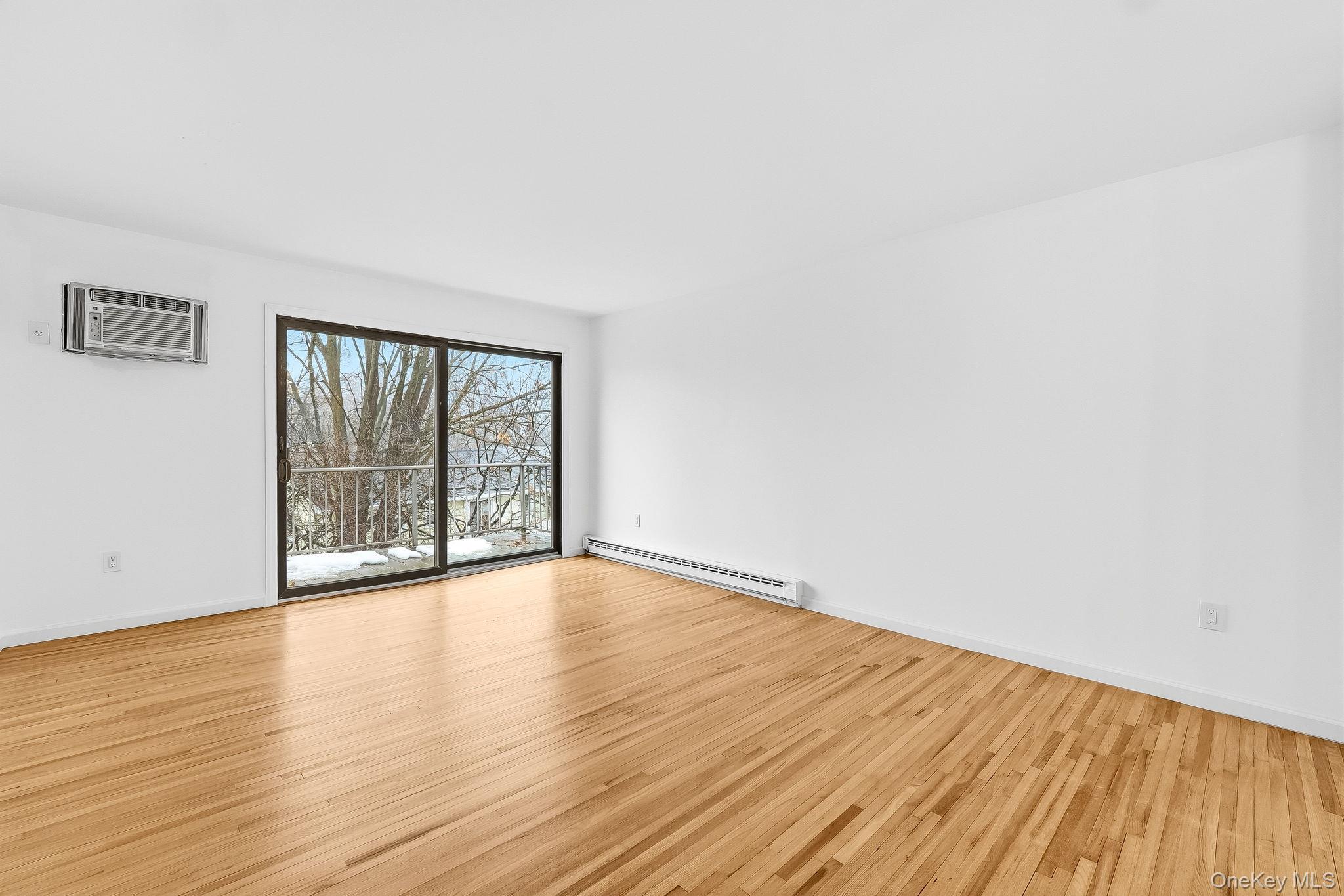 20 Pierces Road, Unit 36 Newburgh, NY 12550 - Photo 6 of 36 a view of an empty room with wooden floor and a window