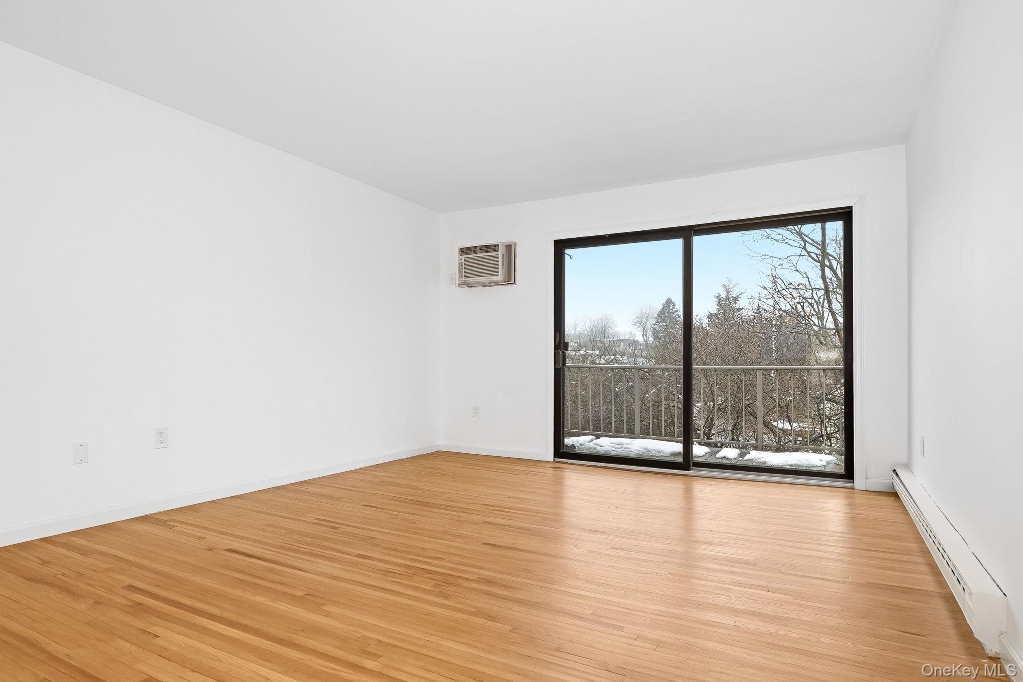 20 Pierces Road, Unit 36 Newburgh, NY 12550 - Photo 9 of 36 an empty room with wooden floor and windows