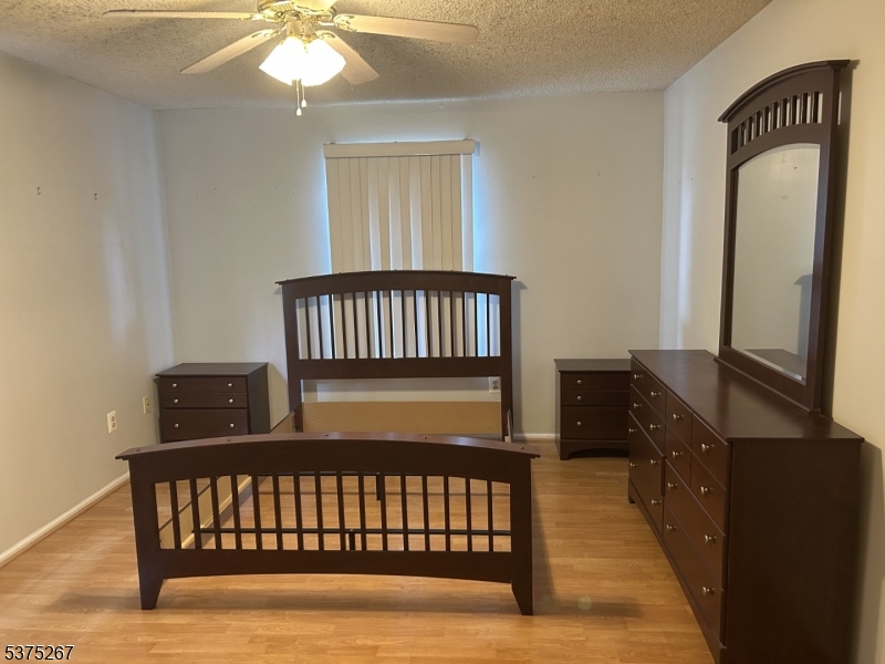 2512 Lindsley Road Bridgewater, NJ 08807 - Photo 11 of 39 a bedroom with a bed and wooden floor