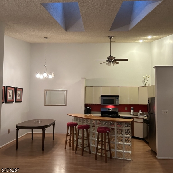2512 Lindsley Road Bridgewater, NJ 08807 - Photo 2 of 39 a kitchen with stainless steel appliances a dining table chairs and wooden floor