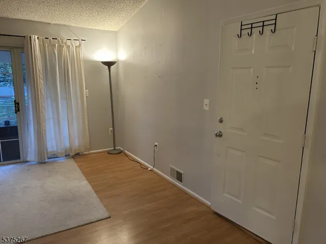 a view of a room with a fireplace and cabinet