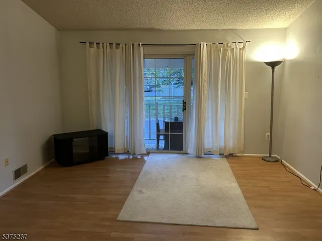 a view of a room with a door and a window