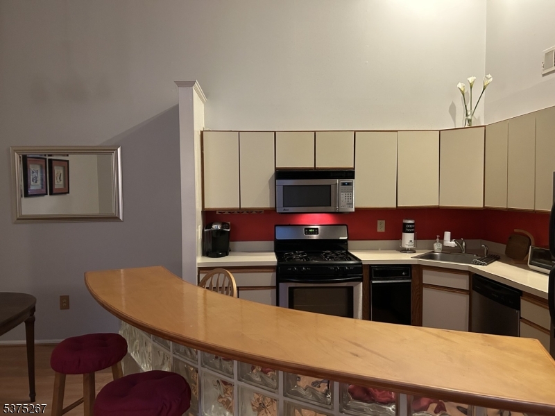 2512 Lindsley Road Bridgewater, NJ 08807 - Photo 4 of 39 a kitchen with a sink a stove and chairs