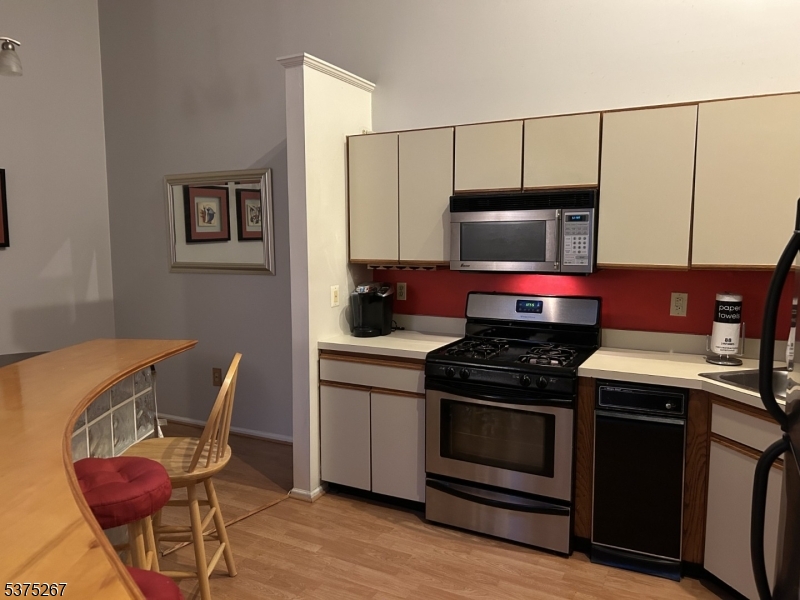 2512 Lindsley Road Bridgewater, NJ 08807 - Photo 5 of 39 a kitchen with a stove and a microwave