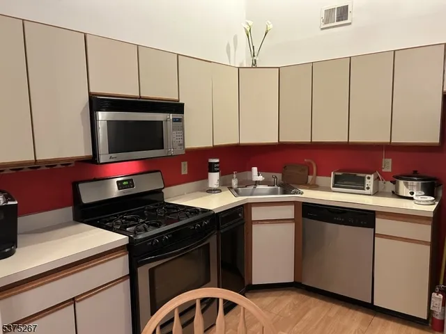a kitchen with a sink stove and cabinets