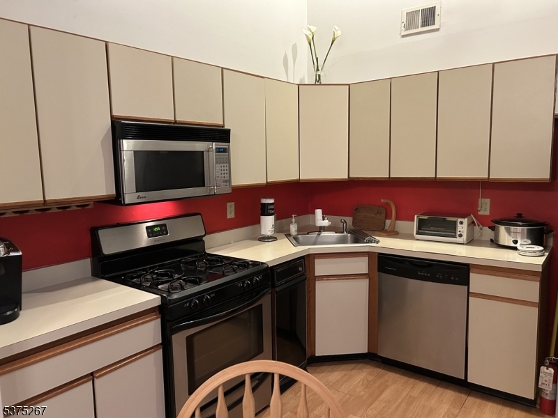 2512 Lindsley Road Bridgewater, NJ 08807 - Photo 6 of 39 a kitchen with a sink stove and cabinets
