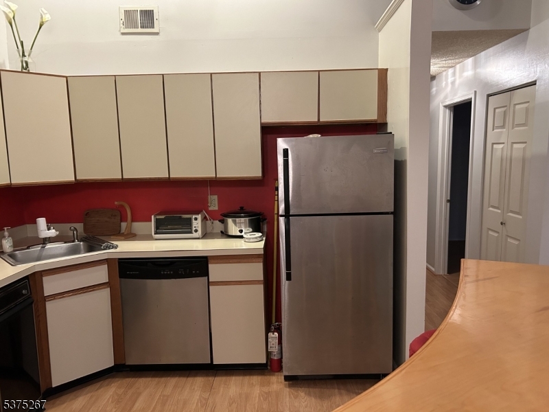 2512 Lindsley Road Bridgewater, NJ 08807 - Photo 7 of 39 a kitchen with a refrigerator and a sink