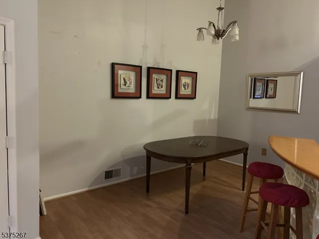 a view of a room with furniture and wooden floor