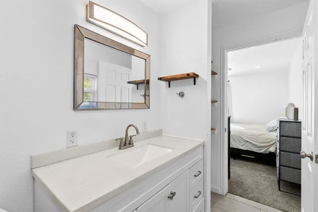 a en suite bathroom with a sink and mirror