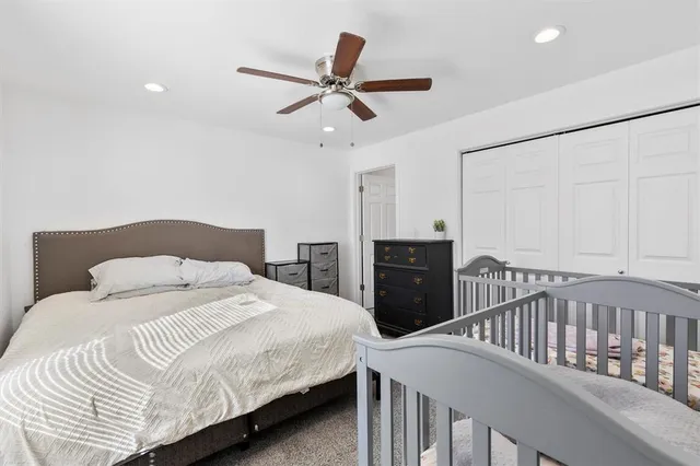 a bedroom with a bed and ceiling fan