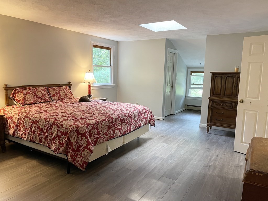 18 Boxford Road Topsfield, MA 01983 - Photo 13 of 25 a bedroom with a bed and wooden floor