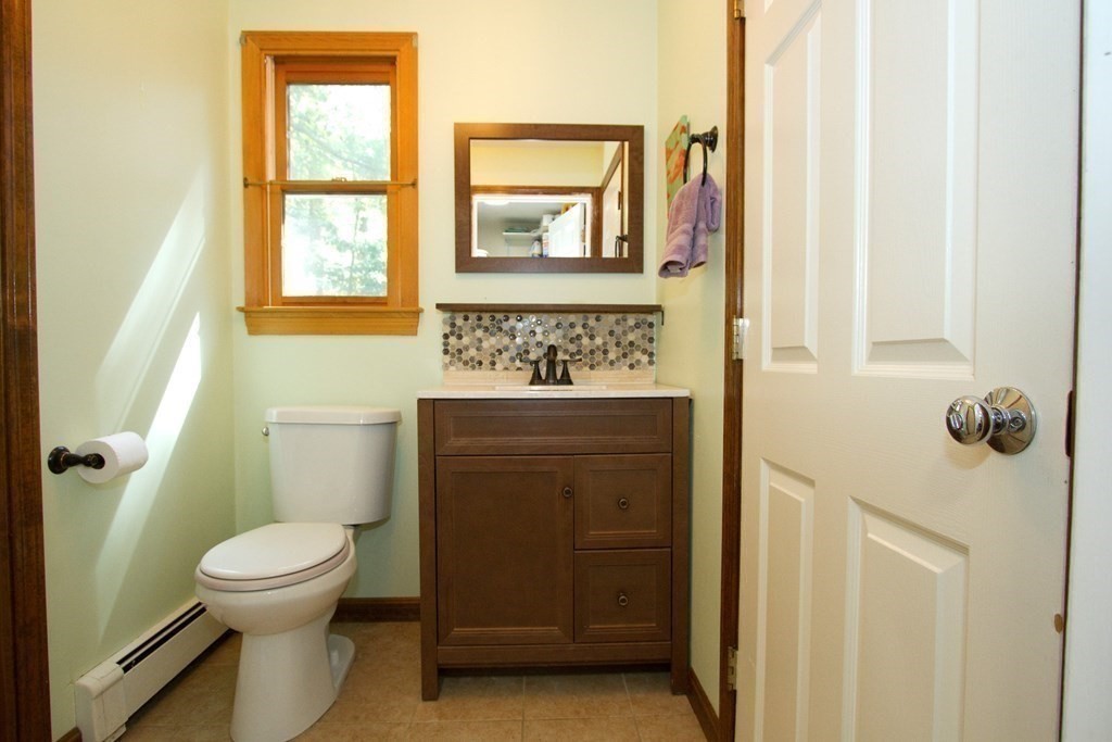 18 Boxford Road Topsfield, MA 01983 - Photo 14 of 25 a bathroom with a toilet sink vanity granite and a window