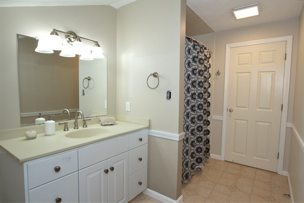 18 Boxford Road Topsfield, MA 01983 - Photo 17 of 25 a bathroom with a sink a vanity and a mirror