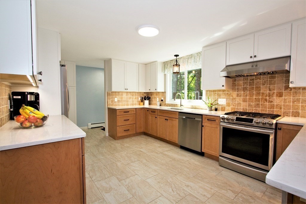 18 Boxford Road Topsfield, MA 01983 - Photo 2 of 25 a kitchen with stainless steel appliances kitchen island granite countertop a sink stove and refrigerator
