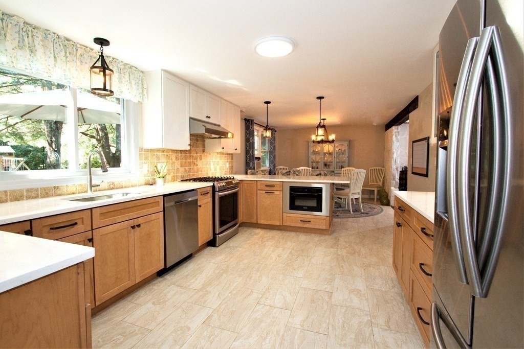 18 Boxford Road Topsfield, MA 01983 - Photo 5 of 25 a large kitchen with stainless steel appliances granite countertop a stove a sink dishwasher and a refrigerator
