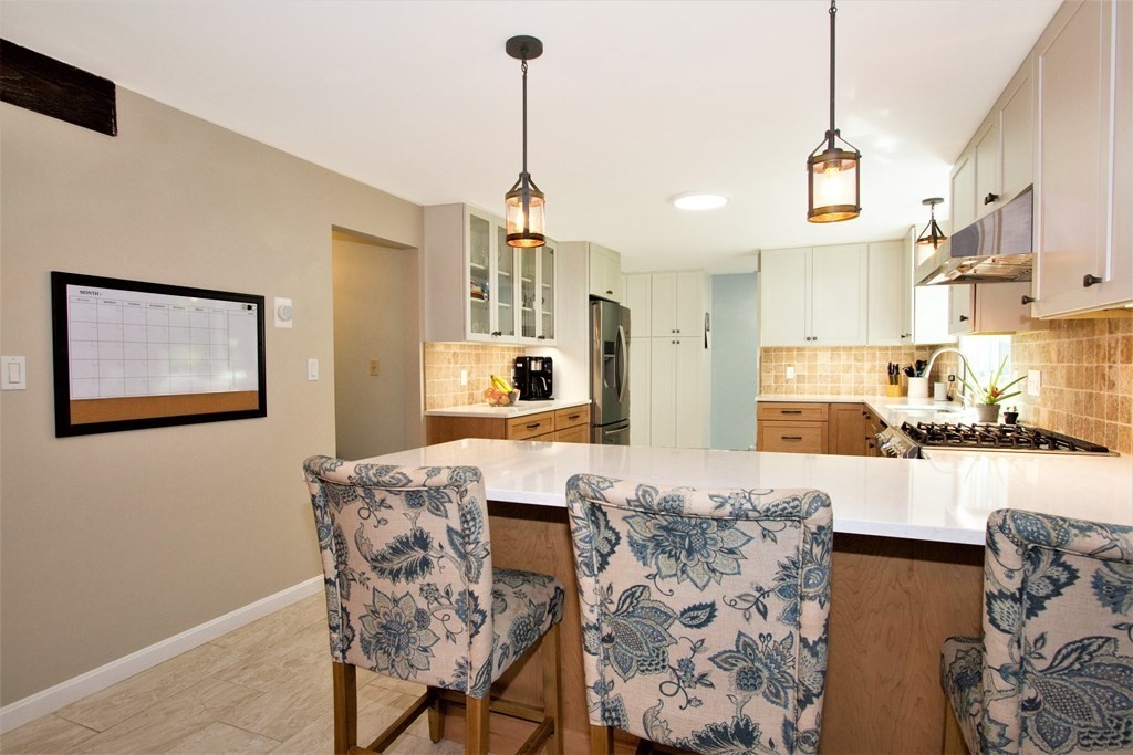 18 Boxford Road Topsfield, MA 01983 - Photo 7 of 25 a view of a kitchen and dining room with a chandelier