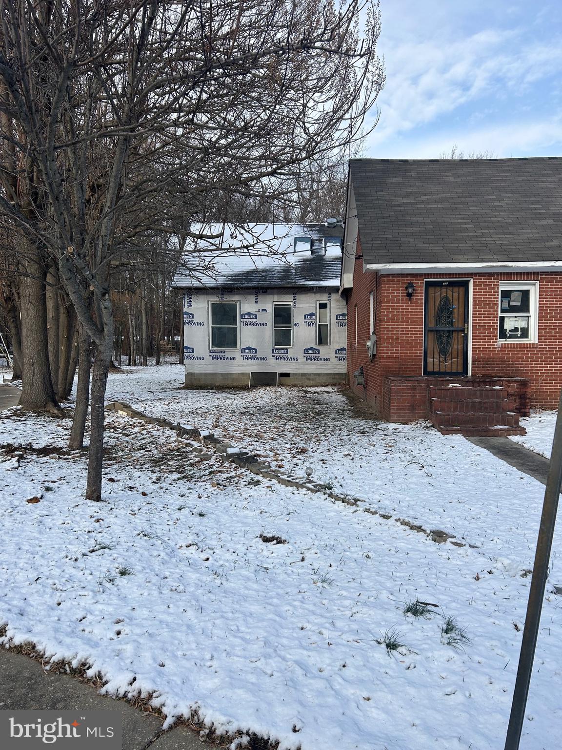 6600 Woodland Road Morningside, MD 20746 - Photo 3 of 100 a front view of a house with a yard covered in snow