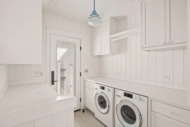 a view of washer and dryer with kitchen in the background