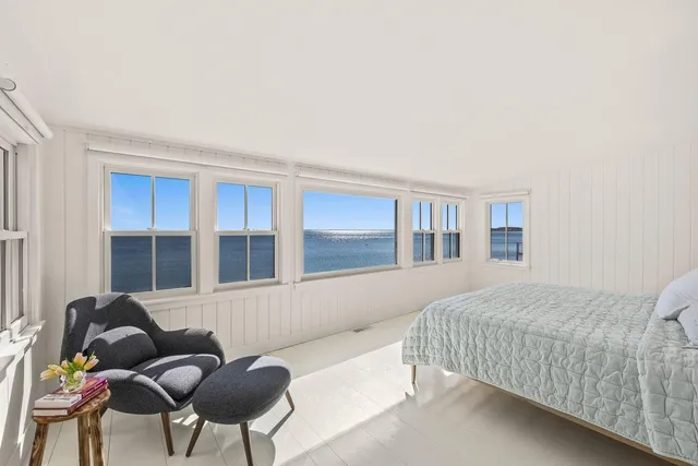 a bedroom with a bed and chair