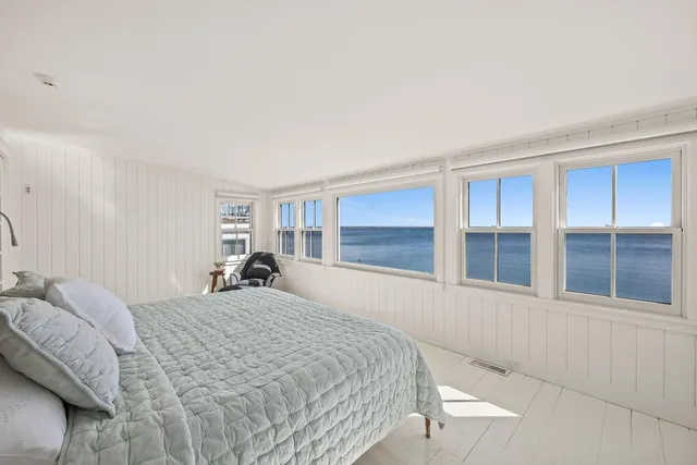 a bedroom with a large bed and a large window