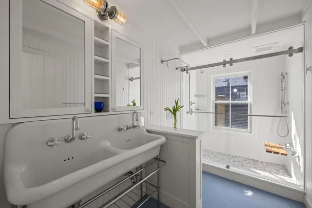 a bathroom with a tub sink and mirror