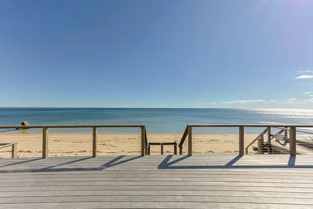 a view of a room with wooden floor and windows
