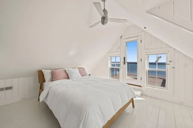 a bedroom with a large bed closet and window