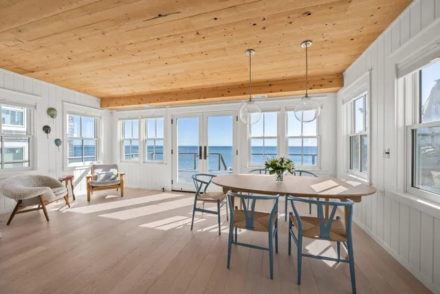a dining room with furniture window and wooden floor