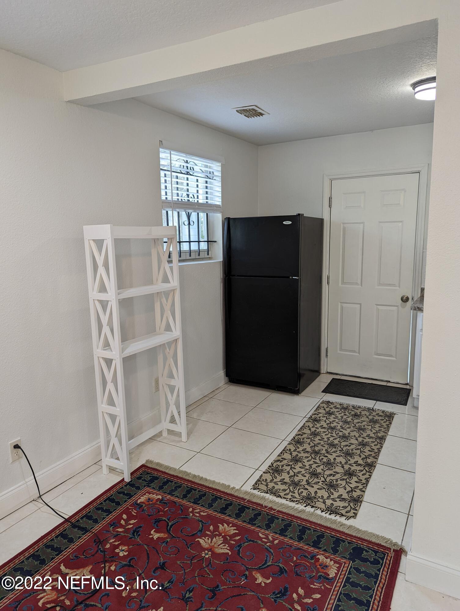 2171 Morehouse Road Jacksonville, FL 32209 - Photo 14 of 17 a view of an empty room with a fireplace and a window