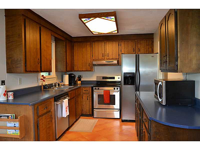 27 Norman Road Jamestown, RI 02835 - Photo 12 of 25 Kitchen. Newer stainless steel appliances and solid wood cabinets suitable for refinishing.