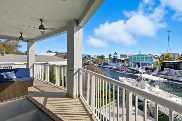 a view of a hallway with wooden floor and cabinet