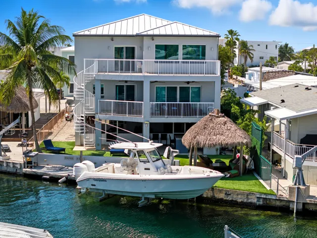 a view of a chairs and table in patio with a lake view