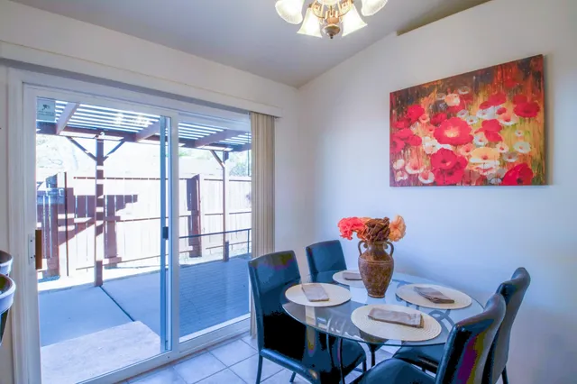 a dining room with furniture and wooden floor