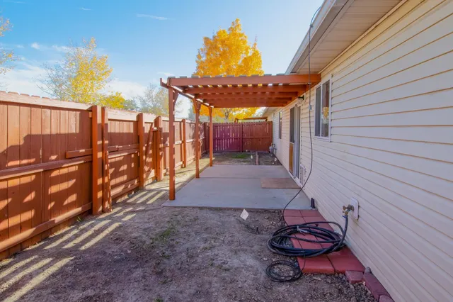 a view of a backyard with wooden fence