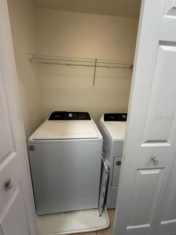2838 Villafuerte Point, Unit 104 Orlando, FL 32835 - Photo 13 of 17 a utility room with dryer and washer