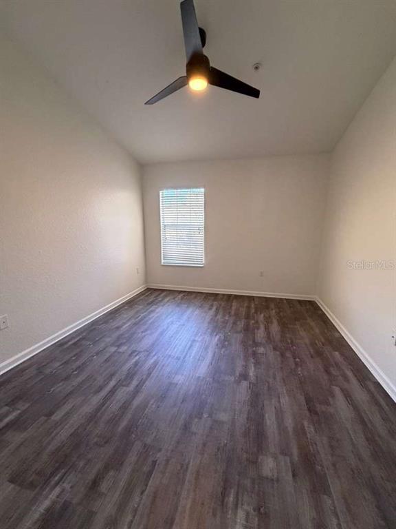 2838 Villafuerte Point, Unit 104 Orlando, FL 32835 - Photo 16 of 17 wooden floor in an empty room with a window