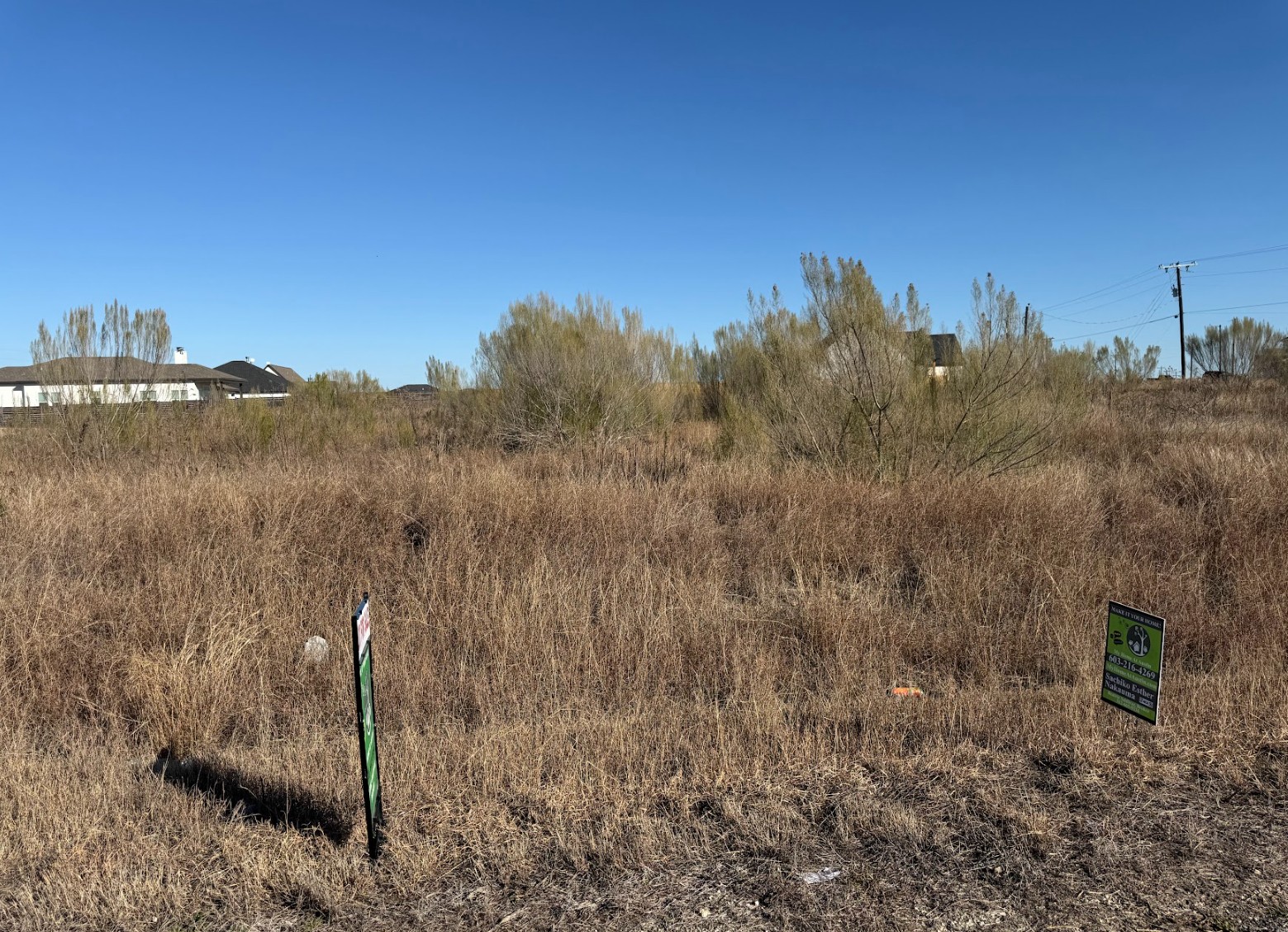 109 Desperado Loop Del Valle, TX 78617 - Photo 2 of 9 a view of a dry yard with trees
