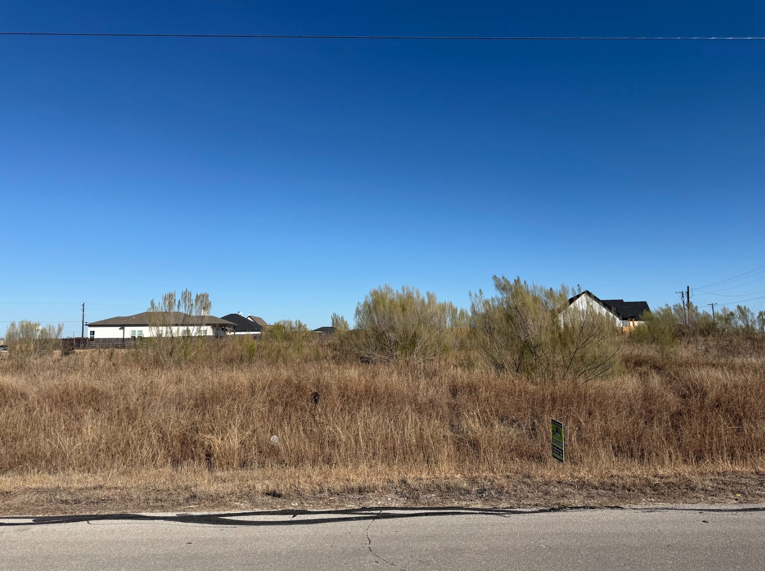 109 Desperado Loop Del Valle, TX 78617 - Photo 5 of 9 a view of a dry yard with trees