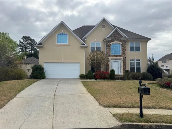 a front view of a house with a yard