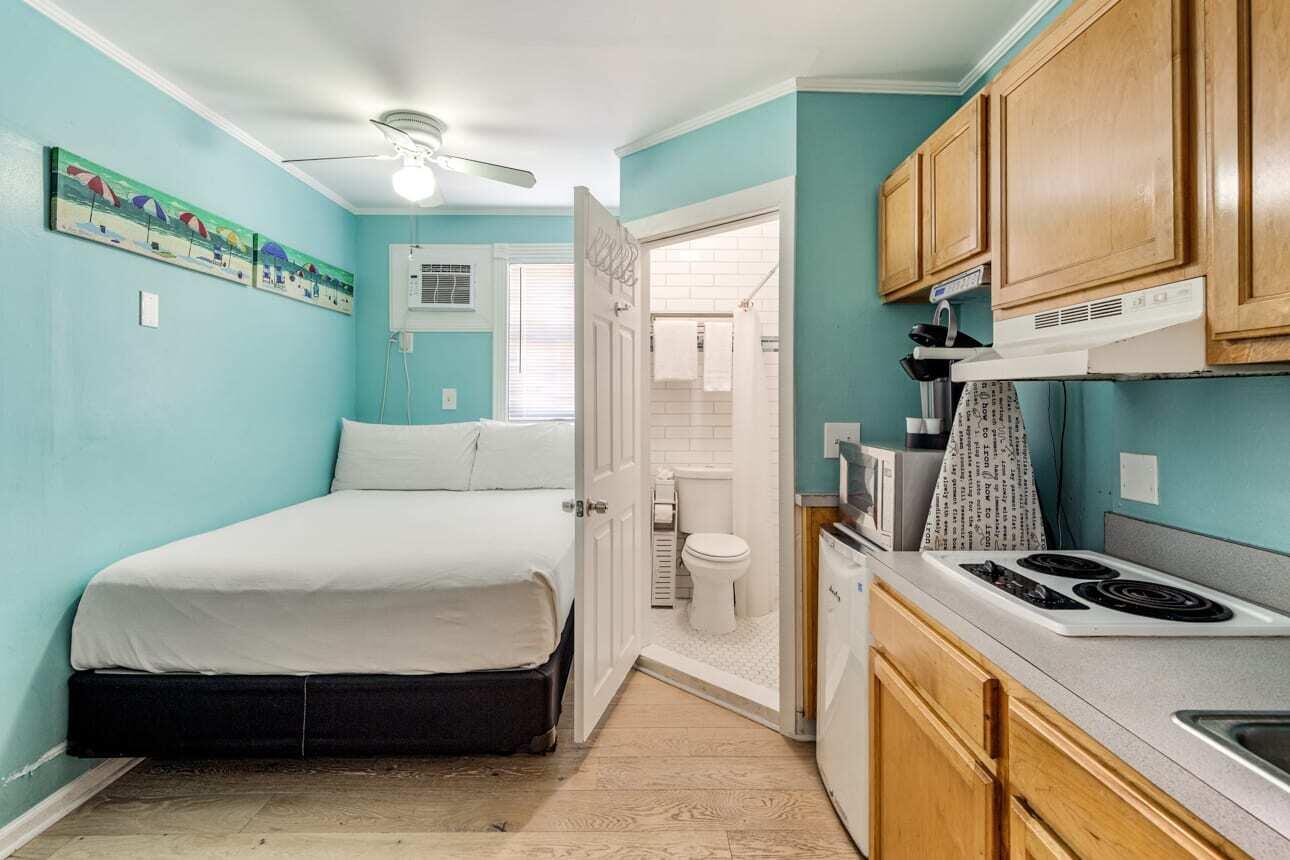 1016 Howe Street, Unit 5 Key West, FL 33040 - Photo 12 of 26 a bedroom with a bed and a chandelier