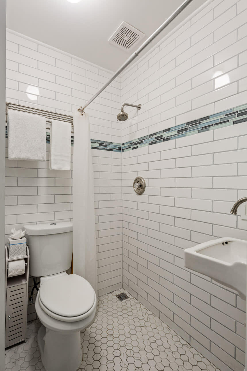 1016 Howe Street, Unit 5 Key West, FL 33040 - Photo 13 of 26 a bathroom with a sink a toilet and shower